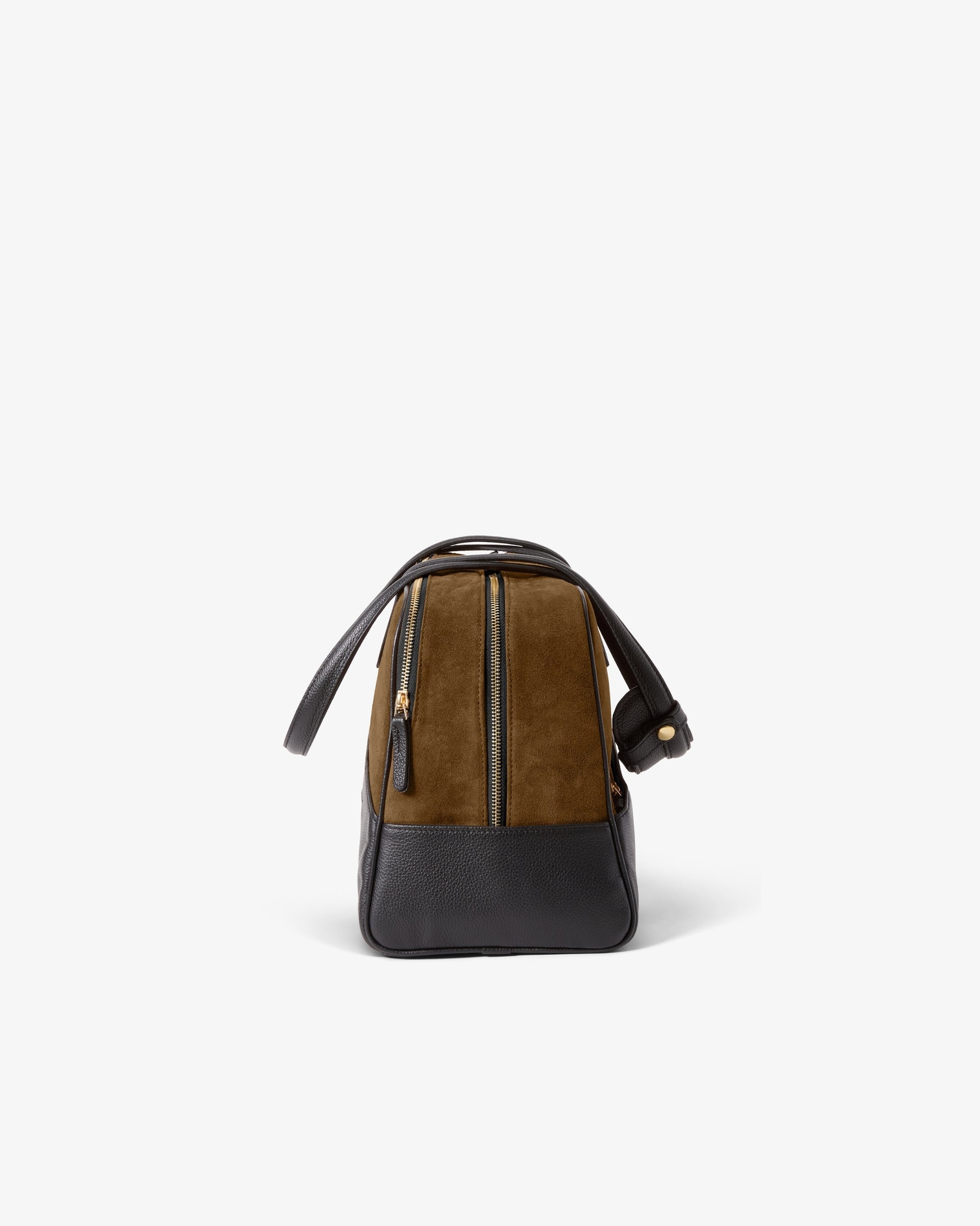 Black and beige leather and suede bag, photographed from the side, showcasing a gold-colored zipper and hardware. 