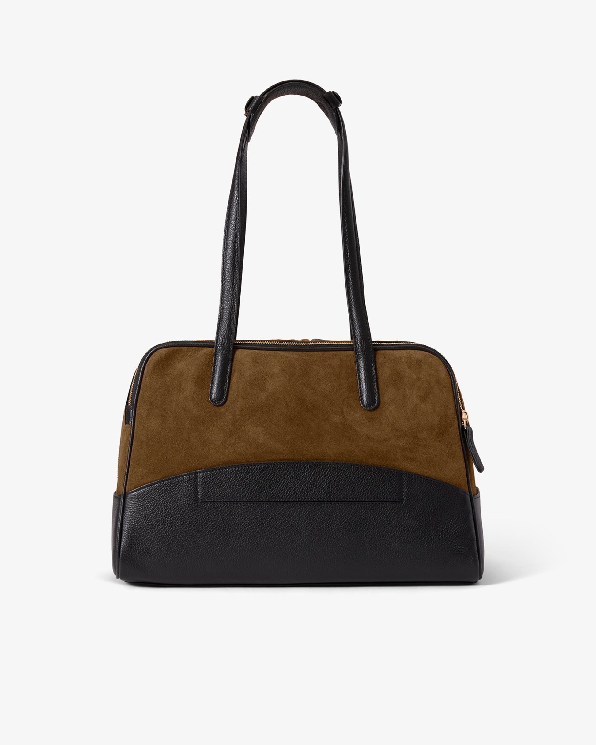 A structured handbag with a color-blocked design, featuring a brown suede upper section, a black textured lower section, a luggage strap, and black leather shoulder straps, shown against a plain white background.