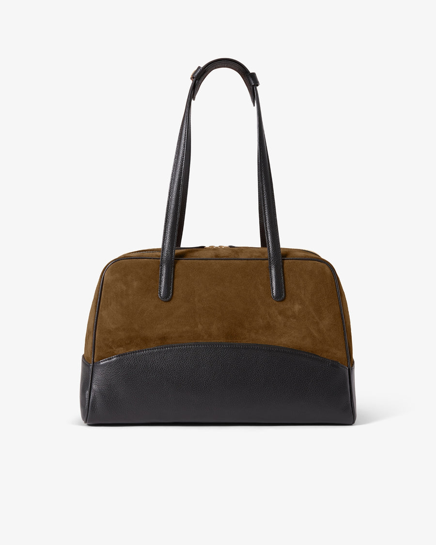 A color-blocked duffel bag featuring a brown suede upper body, a black leather lower base, and black leather shoulder straps, shown against a plain white background.