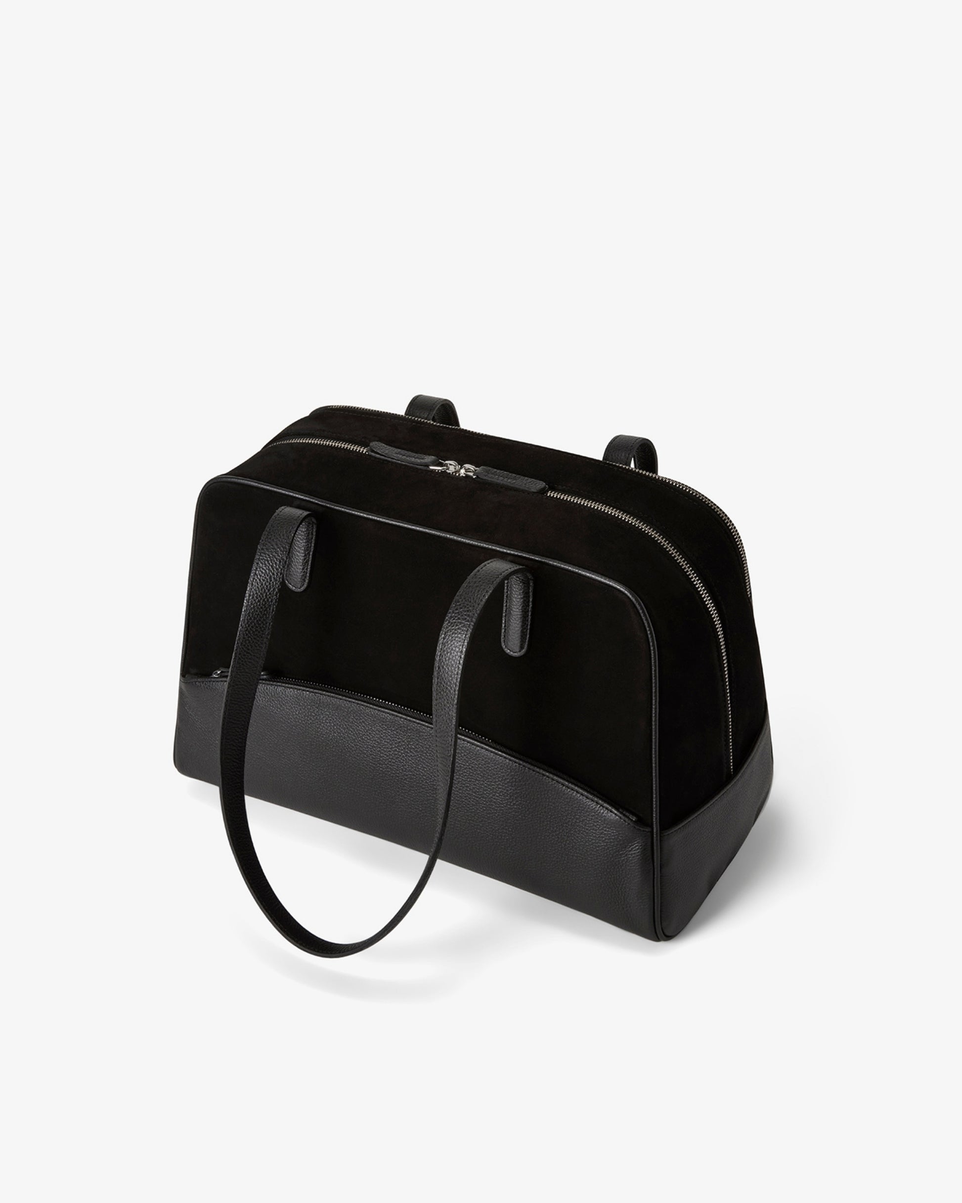 A structured black leather bag with dual top handles and a top zipper closure, photographed on a clean white background.