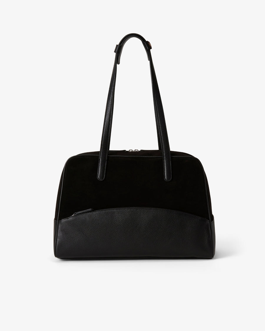 A black shoulder bag with a smooth leather base, a black suede upper section, and dual top handles, shown against a plain light gray background.