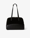 A black structured handbag with a smooth leather front base, a black suede upper section, and dual shoulder straps, shown against a plain light gray background.