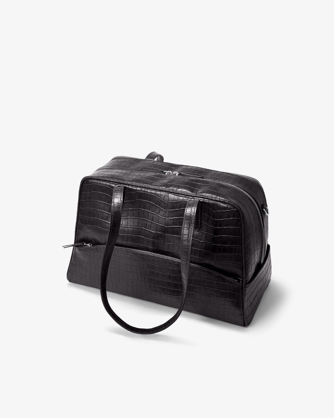 A black crocodile-embossed leather duffel bag with dual top handles and a zippered top closure, photographed on a clean white background.