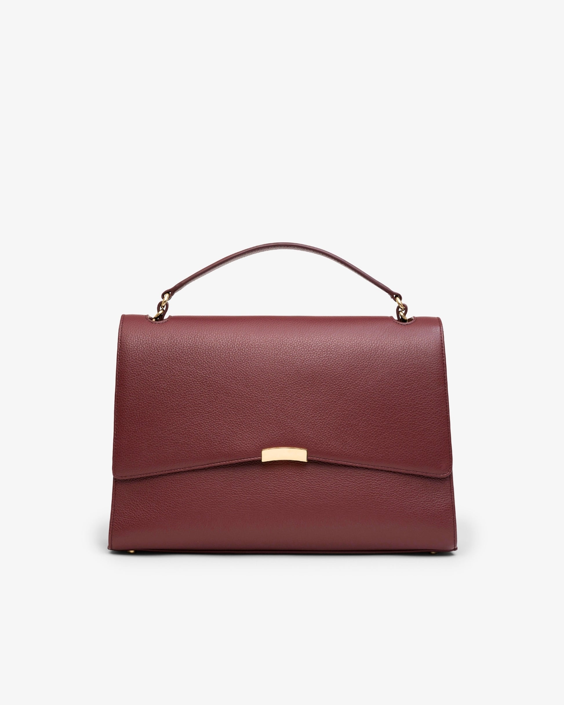 A structured top-handle handbag in textured burgundy leather with a gold-tone metal bar accent on the front flap, shown against a plain white background.