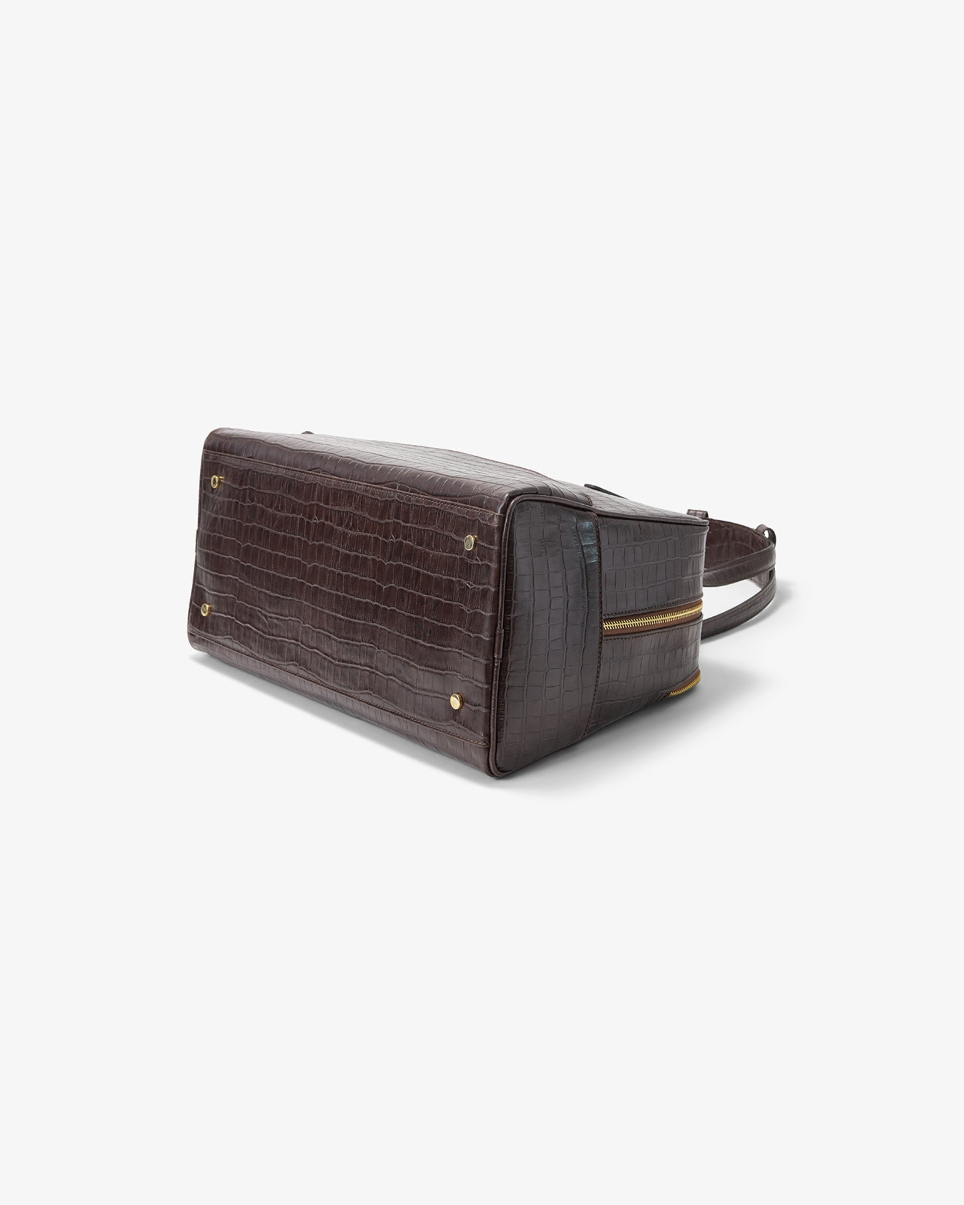 A dark brown crocodile-embossed leather shoulder bag with gold-tone hardware, shown from a side angle on a light gray background.