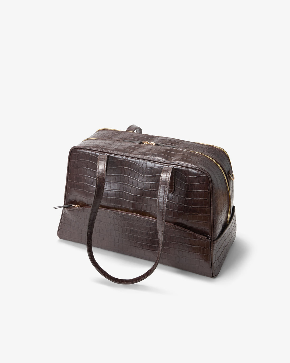 A dark brown crocodile-embossed leather duffel bag with a top handle, shown at an angle on a light gray background.
