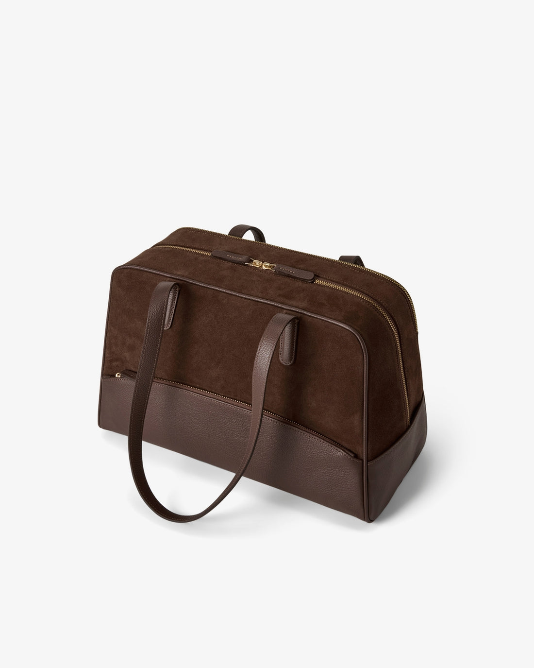 A dark brown travel duffel bag made of suede and leather, featuring a top zipper closure and double shoulder straps, shown on a light gray background.