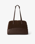 A dark brown leather handbag with a structured dome shape, featuring a back horizontal panel with a luggage strap, a top zipper closure, and two shoulder straps, photographed against a clean white background.