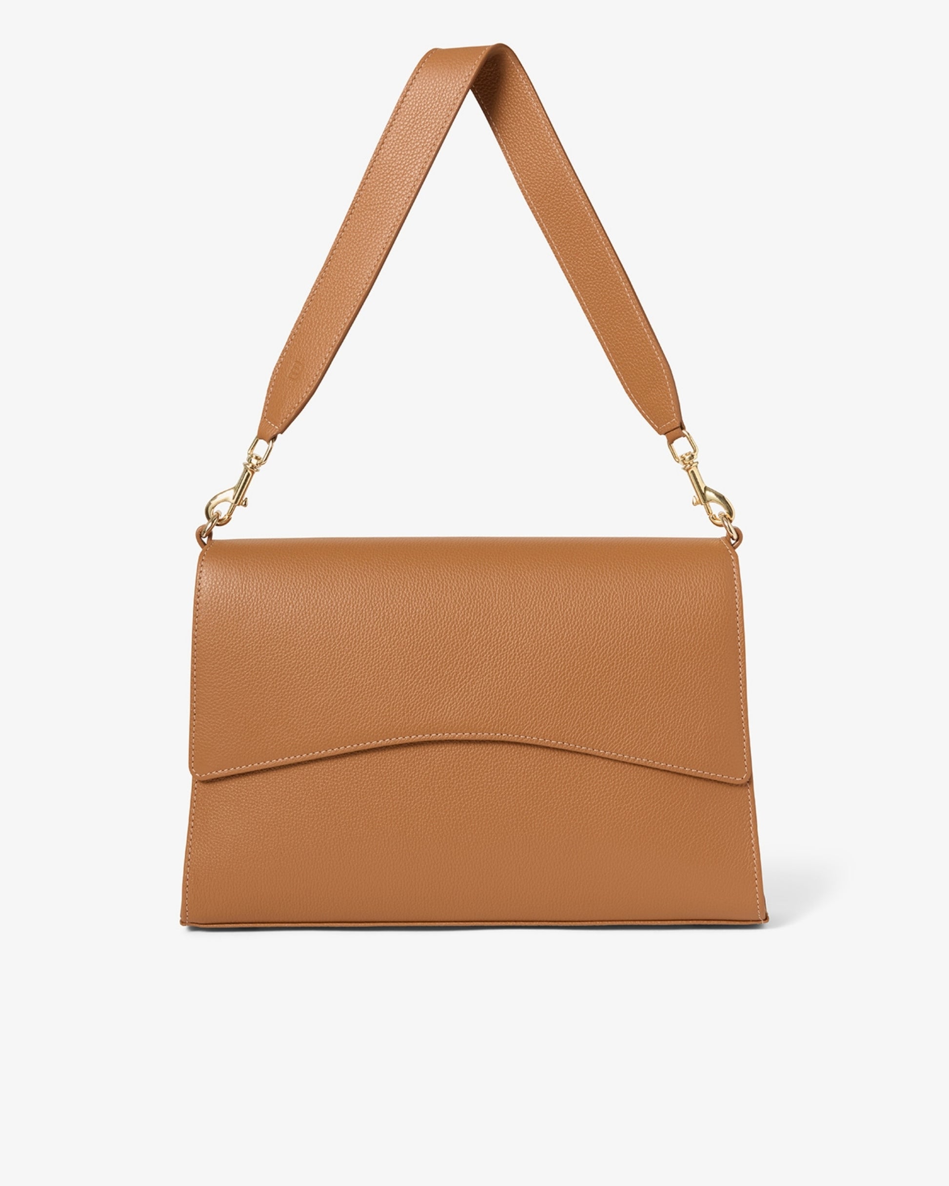 A tan leather shoulder bag with a flap front, curved lower edge, and a matching shoulder strap with gold-tone hardware, shown on a light gray background.