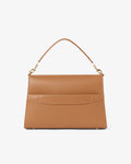 A structured tan leather handbag with a single shoulder strap, gold-tone hardware, and a luggage strap, shown against a plain white background.