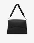 A black textured leather shoulder bag with a wide adjustable strap and silver-tone hardware, shown against a plain white background.