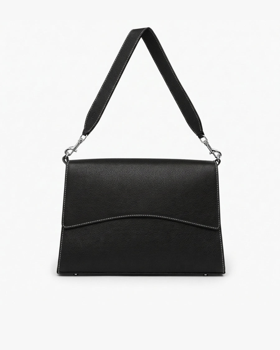 A black textured leather shoulder bag with a wide strap, silver-tone hardware, and contrast stitching, shown against a plain white background.