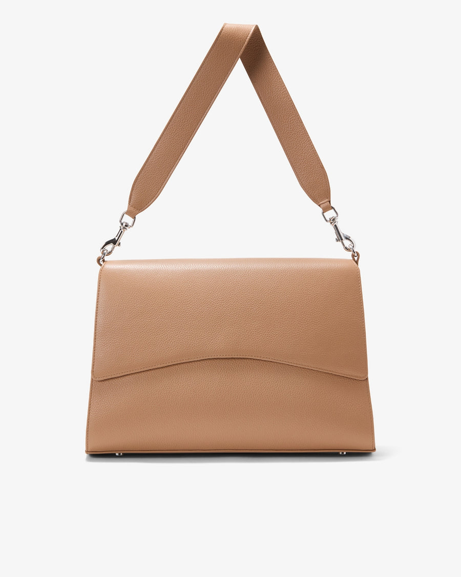 A structured tan leather shoulder bag with a wide strap and silver-tone hardware, shown against a plain light gray background.