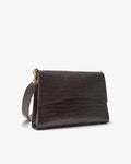 A dark brown crocodile-embossed leather clutch bag with a gold-tone zipper and strap hardware, shown on a clean white background.