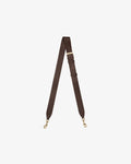 A dark brown leather cross body strap with gold-tone metal hardware, including a buckle, adjustment loops, and two swivel snap hooks, displayed on a light gray background.