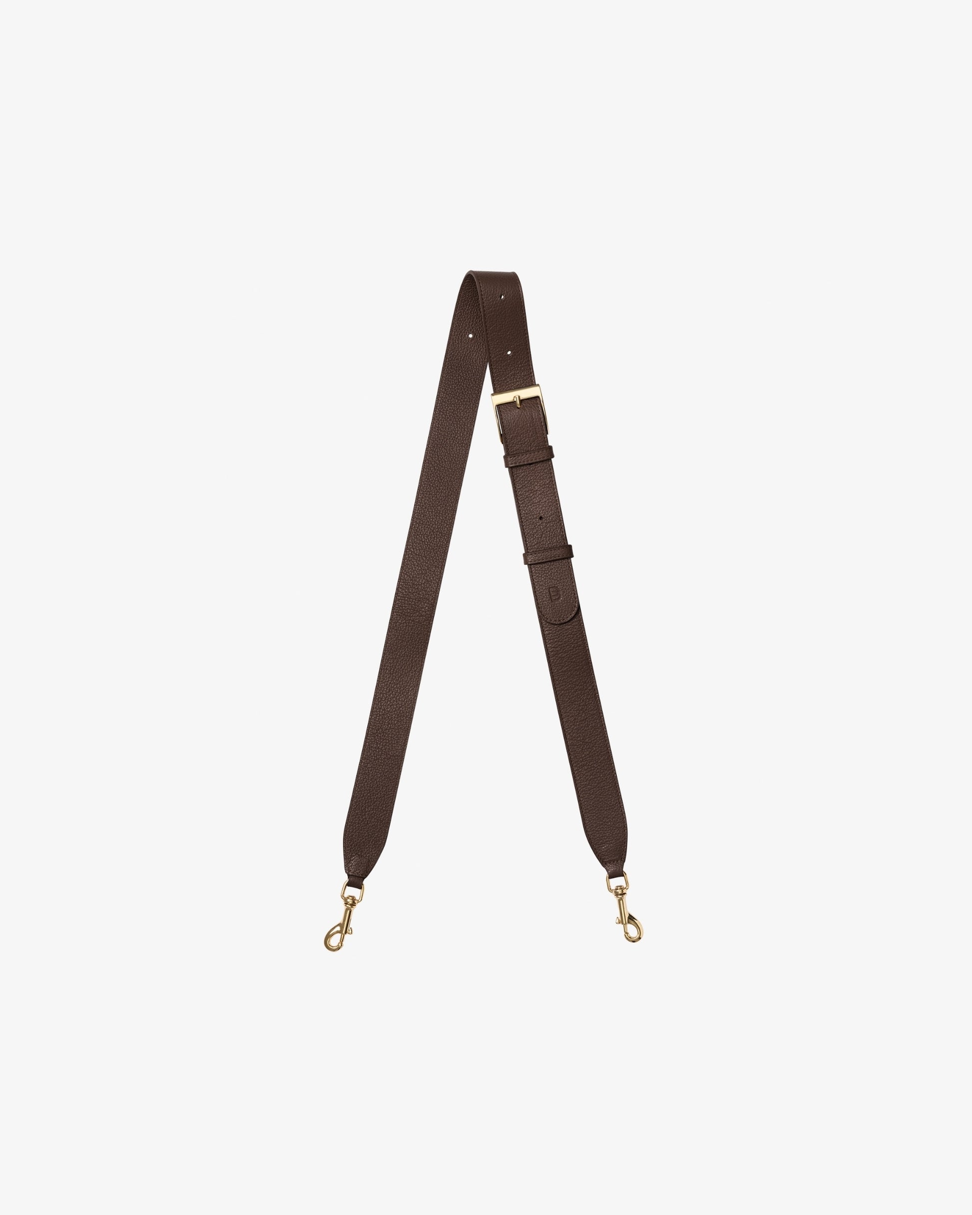 A dark brown leather cross body strap with gold-tone metal hardware, including a buckle, adjustment loops, and two swivel snap hooks, displayed on a light gray background.