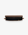 A top-down view of a brown leather bag with gold-tone hardware, shown open to reveal a black interior lining and a central pocket.