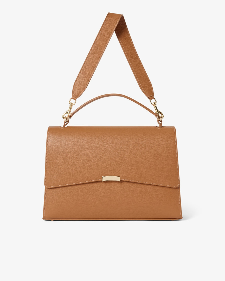 A structured tan leather handbag with a top handle, a detachable shoulder strap, and a small gold-tone metal clasp on the front flap, shown against a plain white background.