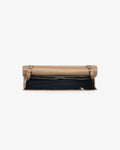A beige leather bag with a black fabric lining, shown from the top against a plain white background.