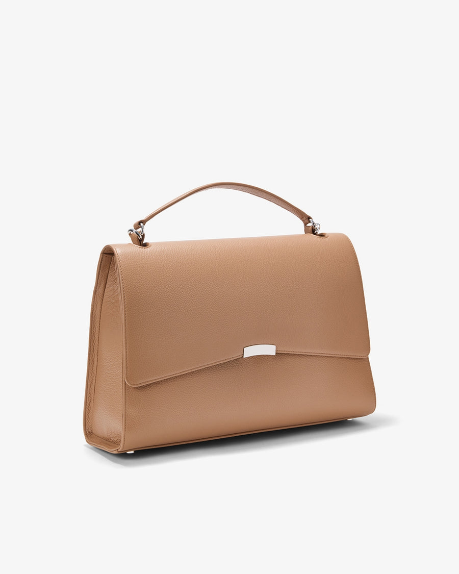 A structured tan leather handbag with a top handle and a small silver metal accent on the front flap, shown against a plain white background.