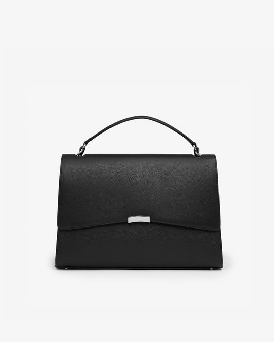 A structured black leather handbag with a top handle and a silver-tone metal accent on the front flap, photographed against a plain white background.