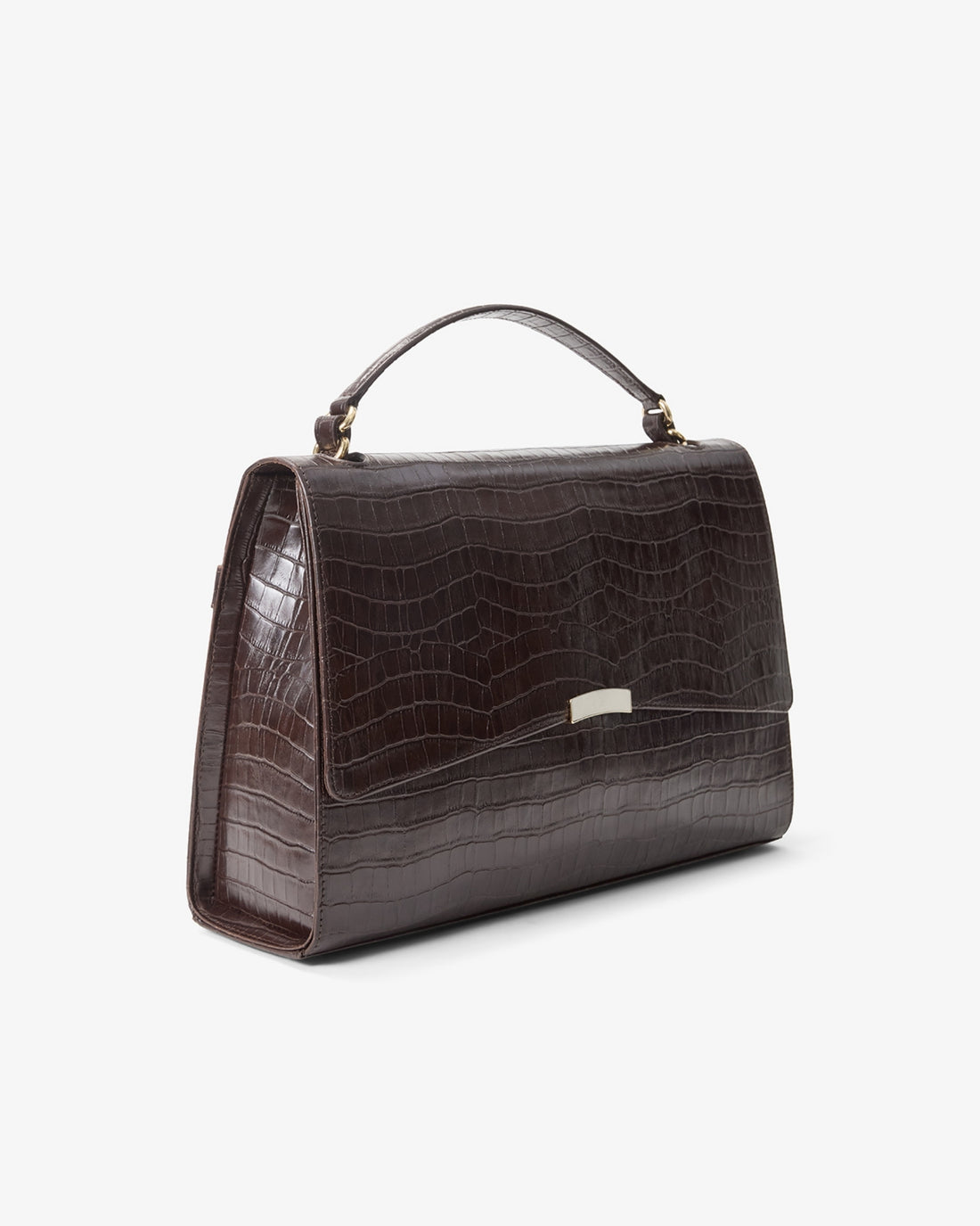 A dark brown crocodile-embossed leather handbag with a top handle and a small gold-tone metal accent on the front, shown against a plain white background.