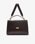 A dark brown crocodile-embossed handbag with a top handle, a shoulder strap, and a gold-tone clasp, shown against a plain light gray background.
