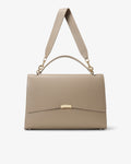 A structured taupe leather handbag with a top handle, an adjustable shoulder strap, and gold-tone hardware, shown against a plain light gray background.