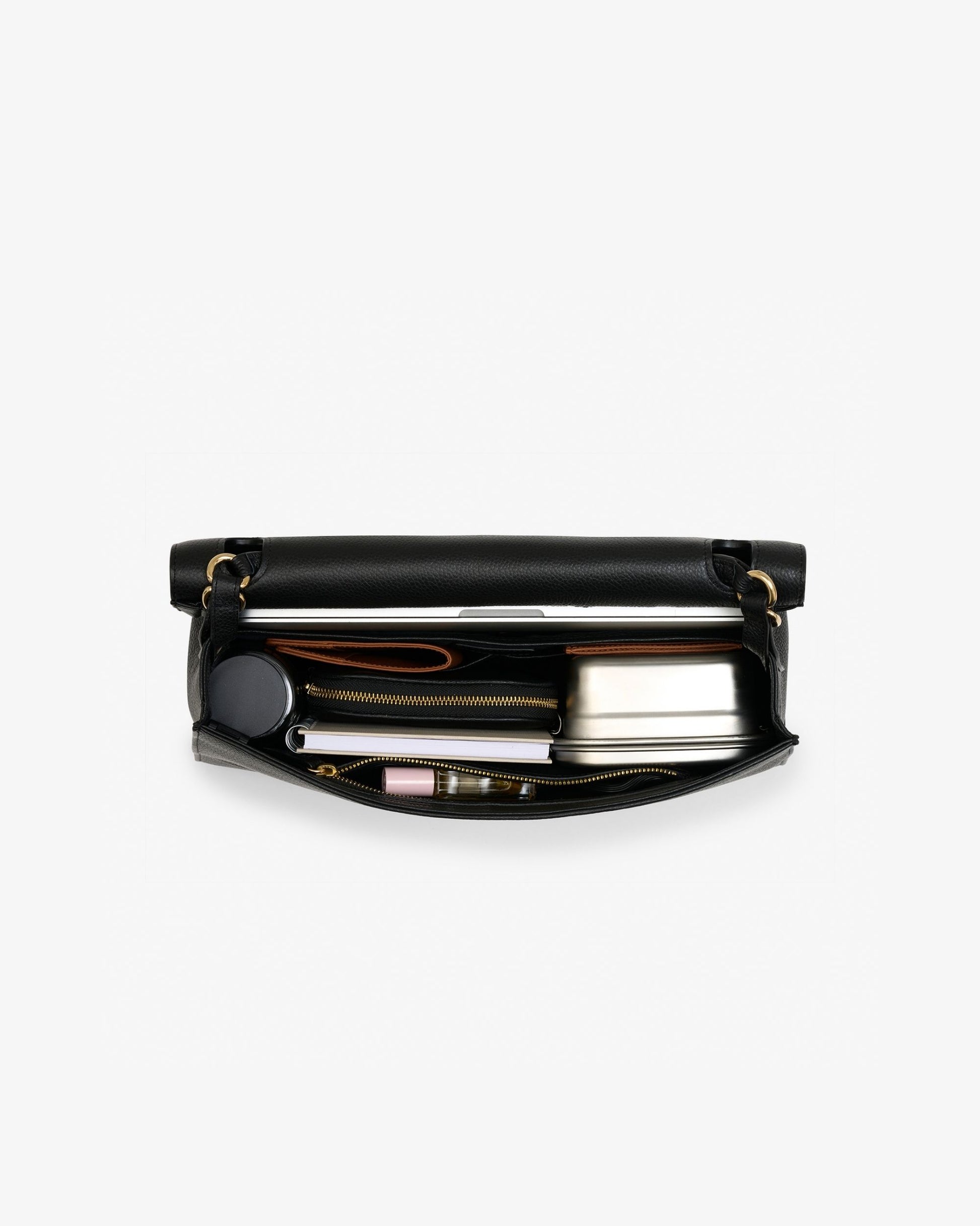 A black leather zippered briefcase shown open from a top-down view, revealing a silver metal lunchbox, a black circular item, and other small accessories inside, set against a plain white background.