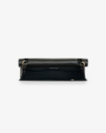 A black leather bag with gold-tone hardware, shown from above against a light gray background.