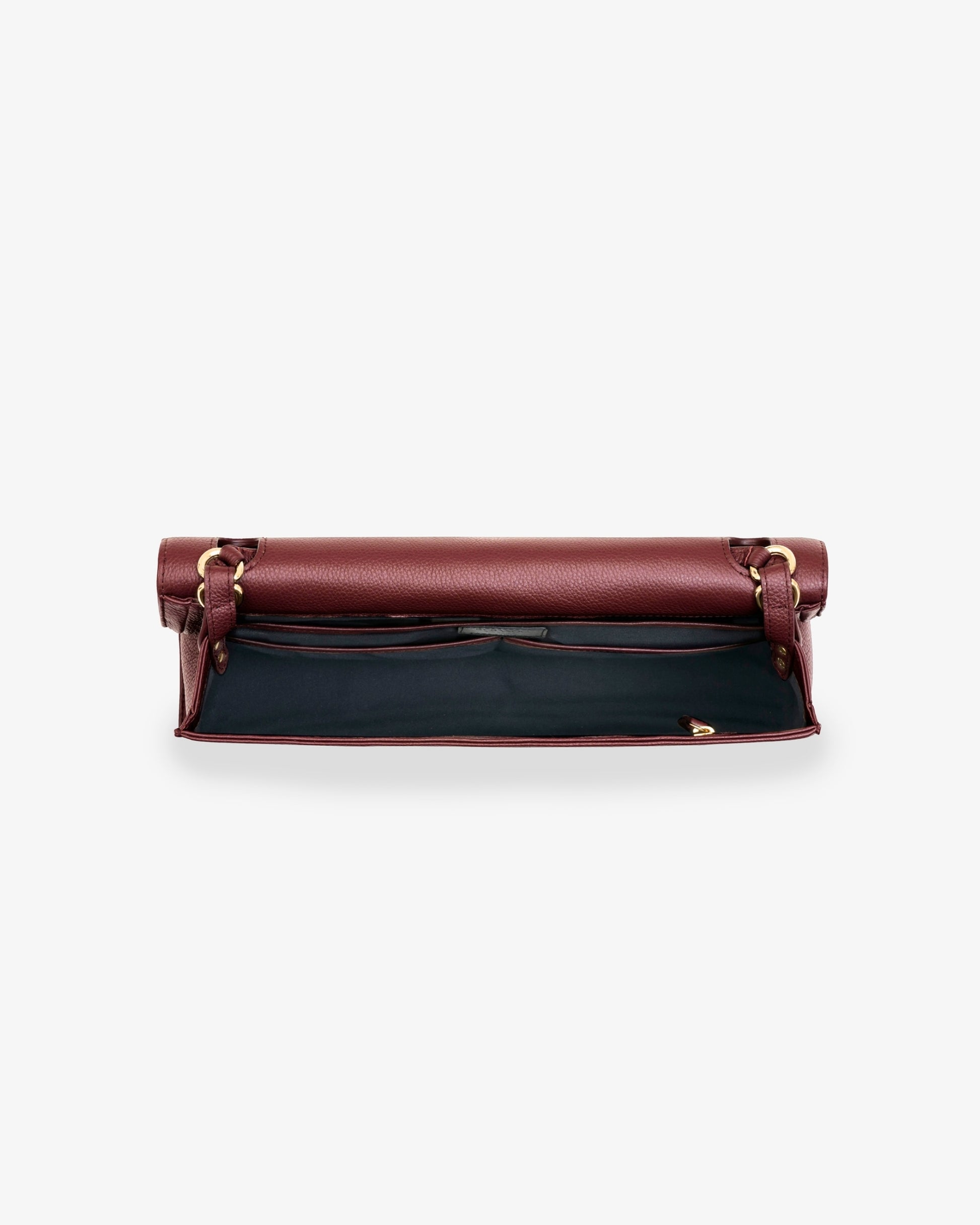 A burgundy leather bag shown from the top, open to reveal a black interior lining and gold-tone hardware, set against a plain light gray background.
