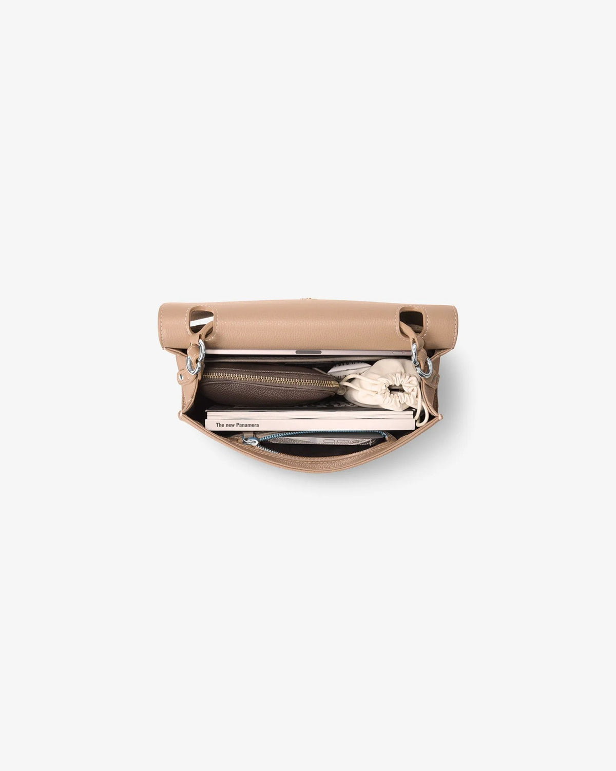 A top-down view of a light beige leather clutch bag with its flap open, showing a dark brown zippered pocket and a white patterned clutch inside, set against a plain light gray background.