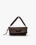 A dark brown leather shoulder bag with a wide strap and a small tassel detail, shown against a plain light gray background.