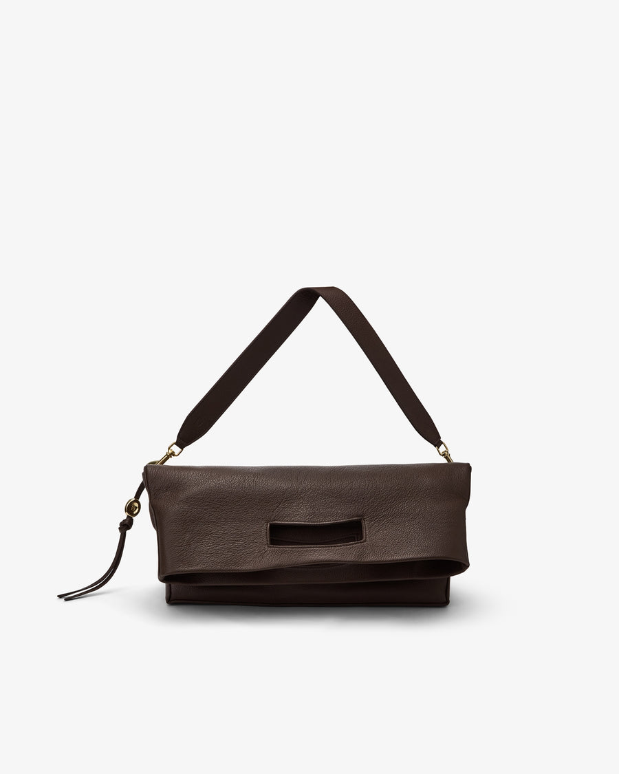 A dark brown leather shoulder bag with a wide strap and a small tassel detail, shown against a plain light gray background.