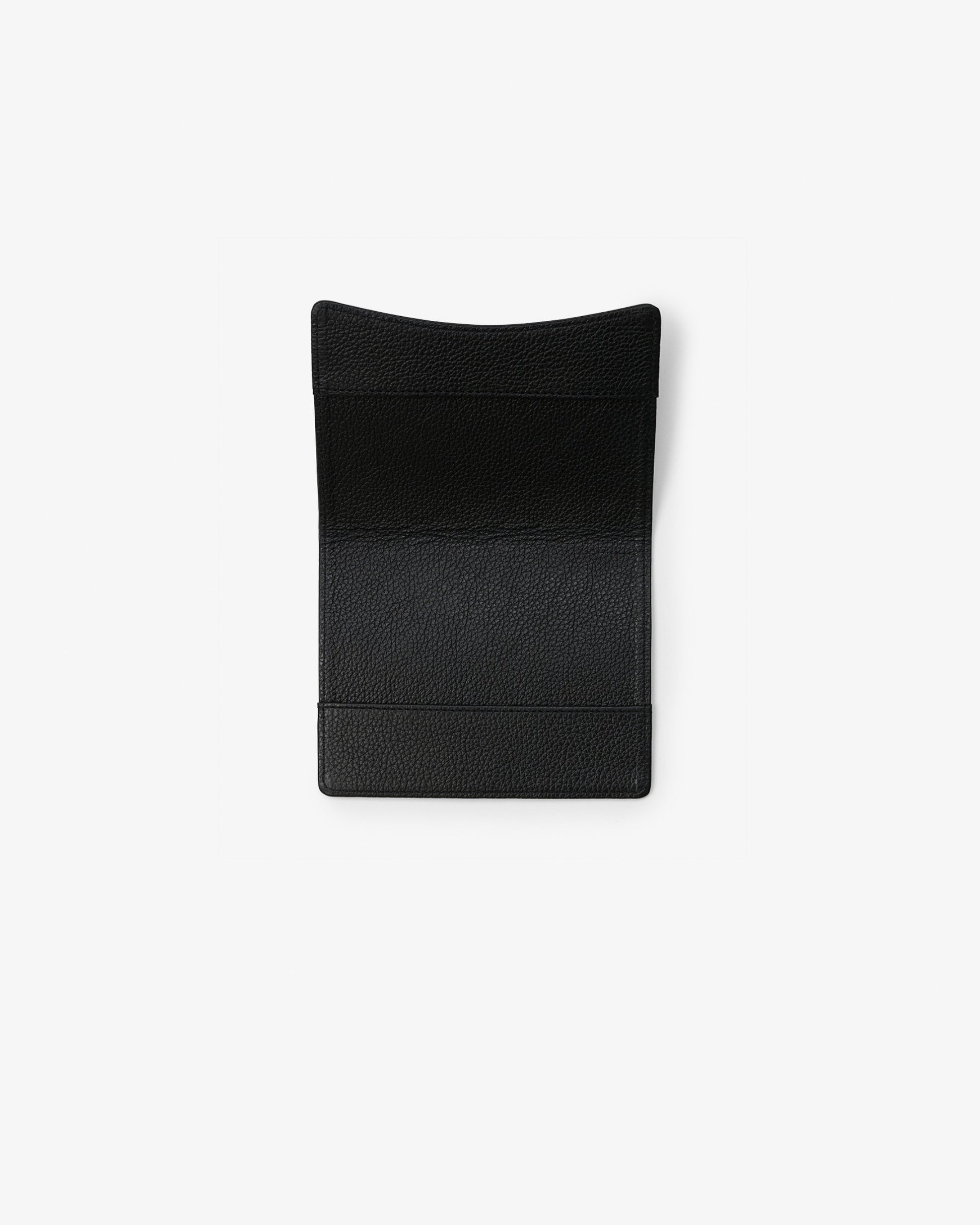 A black textured leather passport holder with a curved top, shown flat against a solid white background.