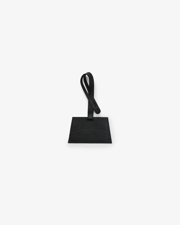 A black leather luggage tag with a rectangular body and a matching loop handle, shown against a plain white background.