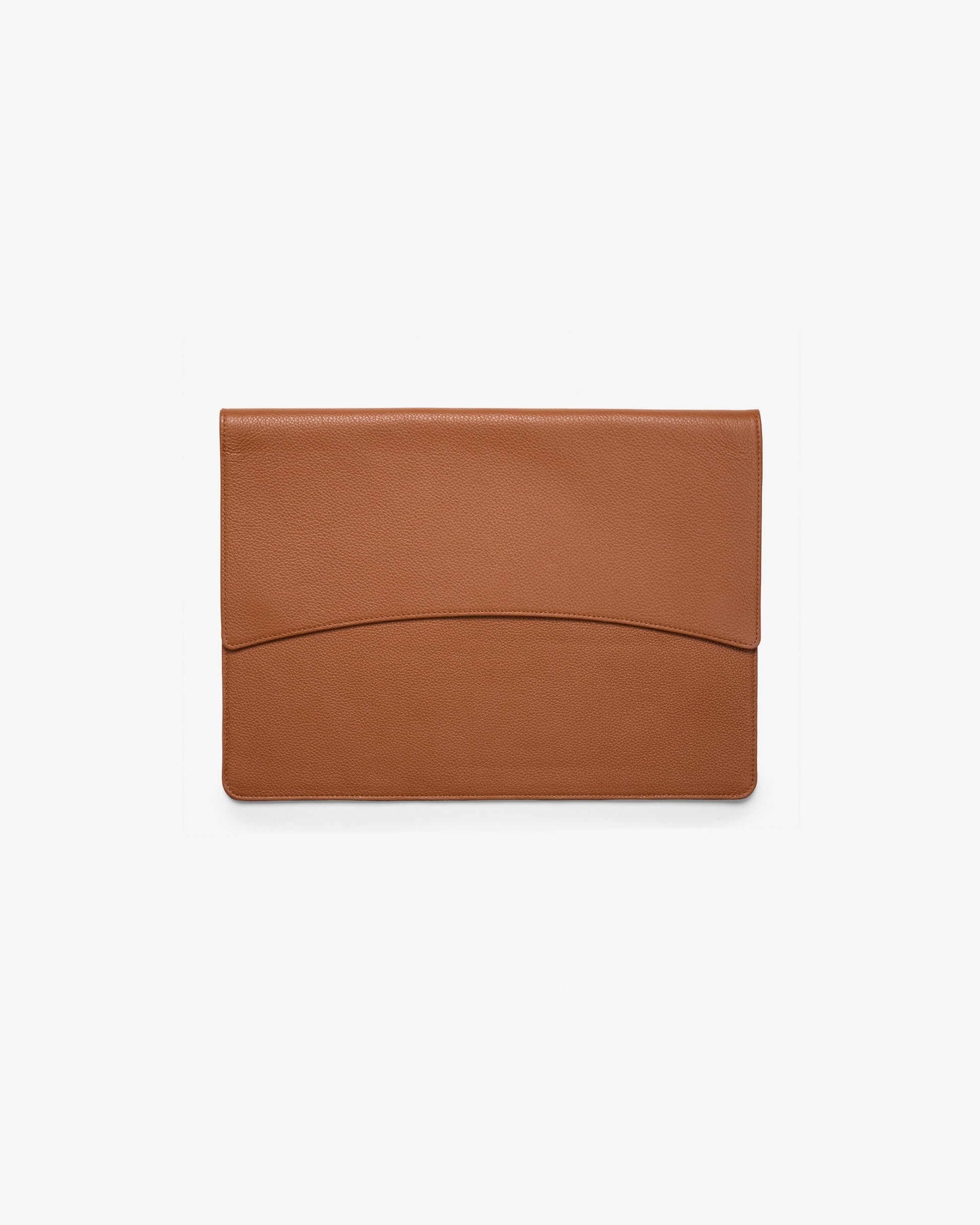A minimalist tan leather laptop holder with a curved seam detail on the front flap, shown flat against a clean white background.