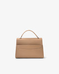 A structured top-handle handbag in a light tan or beige leather with a luggage strap, shown from the back against a plain white background.
