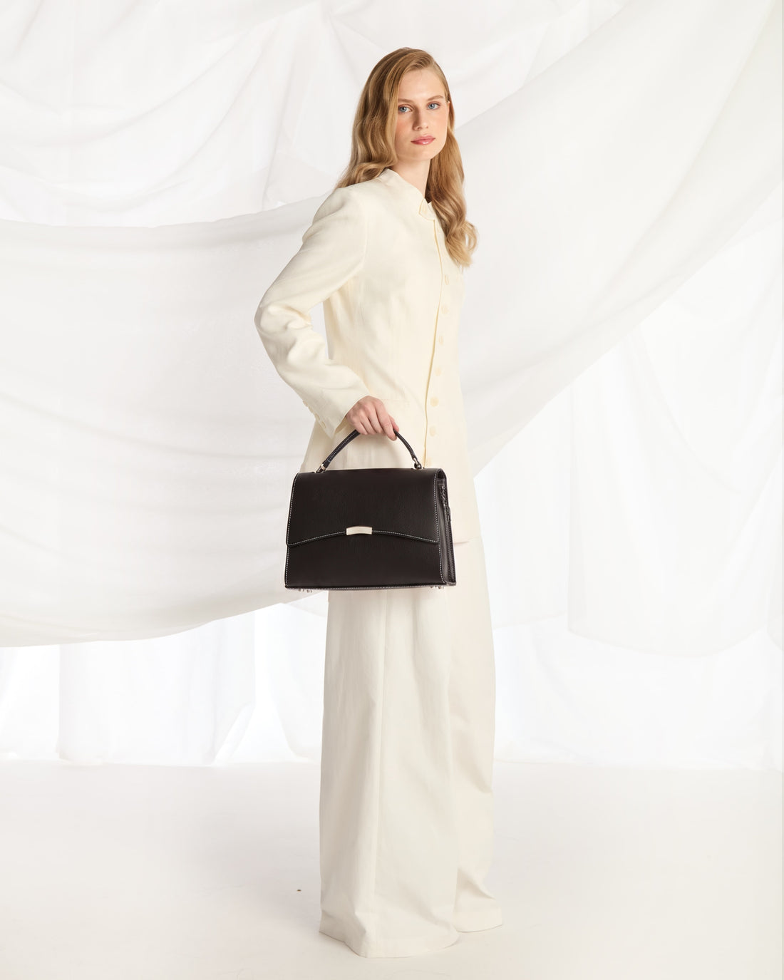 A black leather zippered briefcase with silver hardware, set against a plain white background.