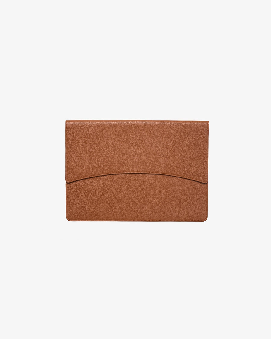 A tan leather laptop cover with a curved center seam, shown flat against a light gray background.