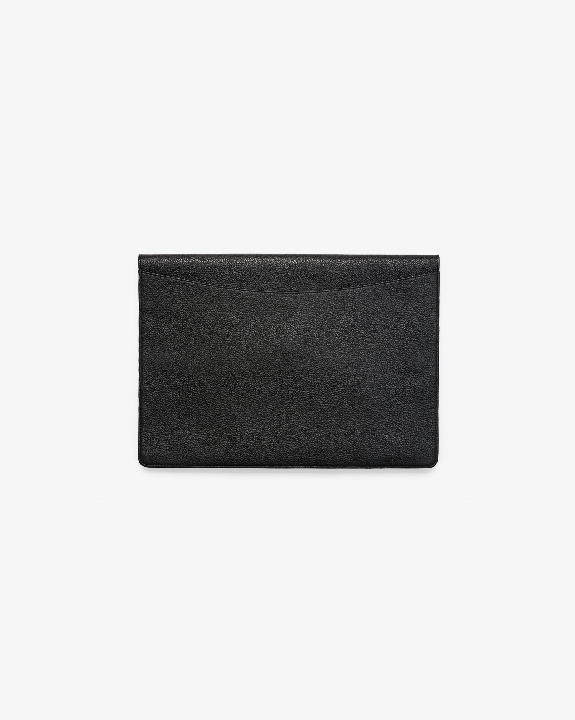A minimalist black leather envelope-style laptop case with a subtle textured finish and an embossed "B" logo, photographed flat from the back against a clean white background.