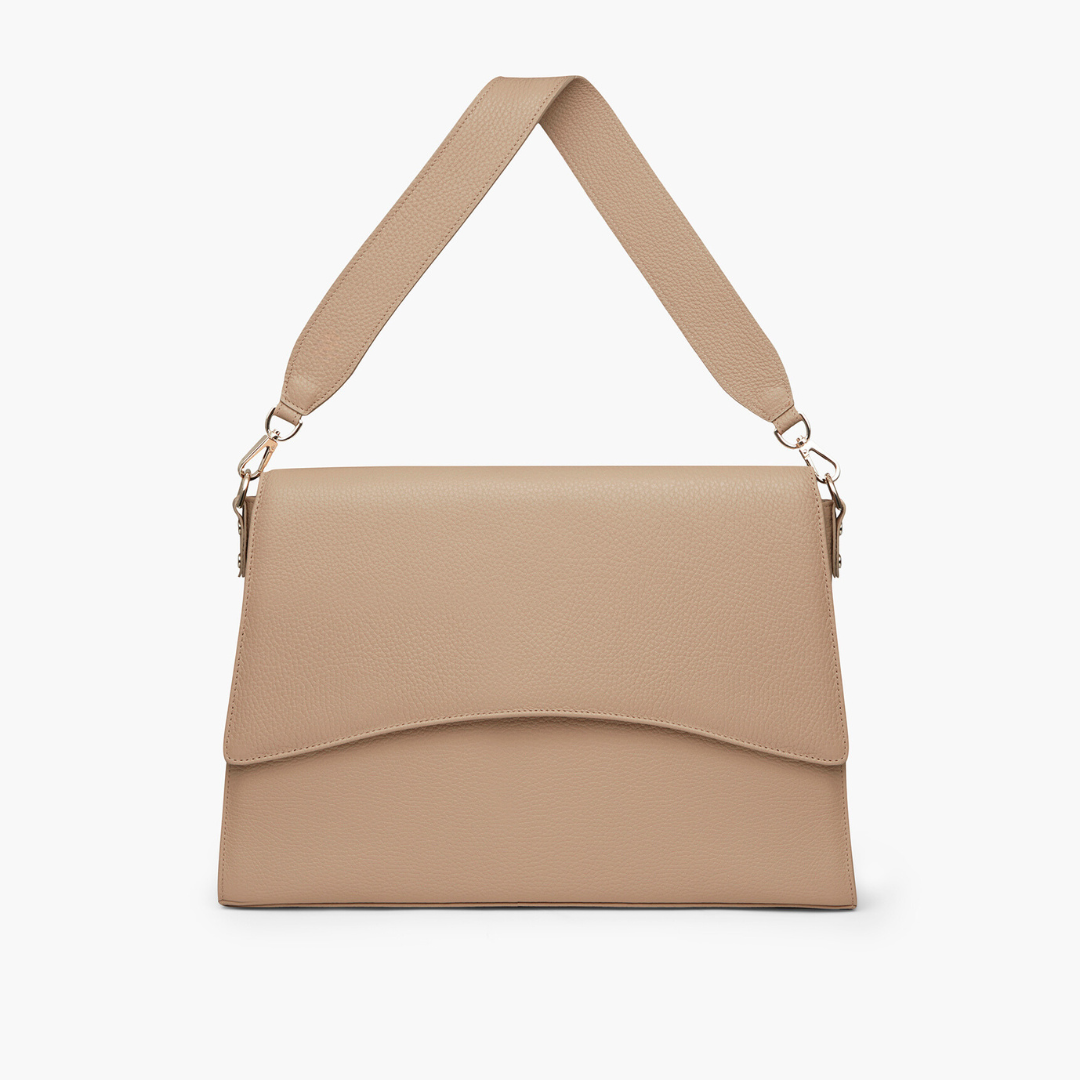A beige laptop bag with grained leather and light gold metalware. It has a detachable shoulder strap. 
