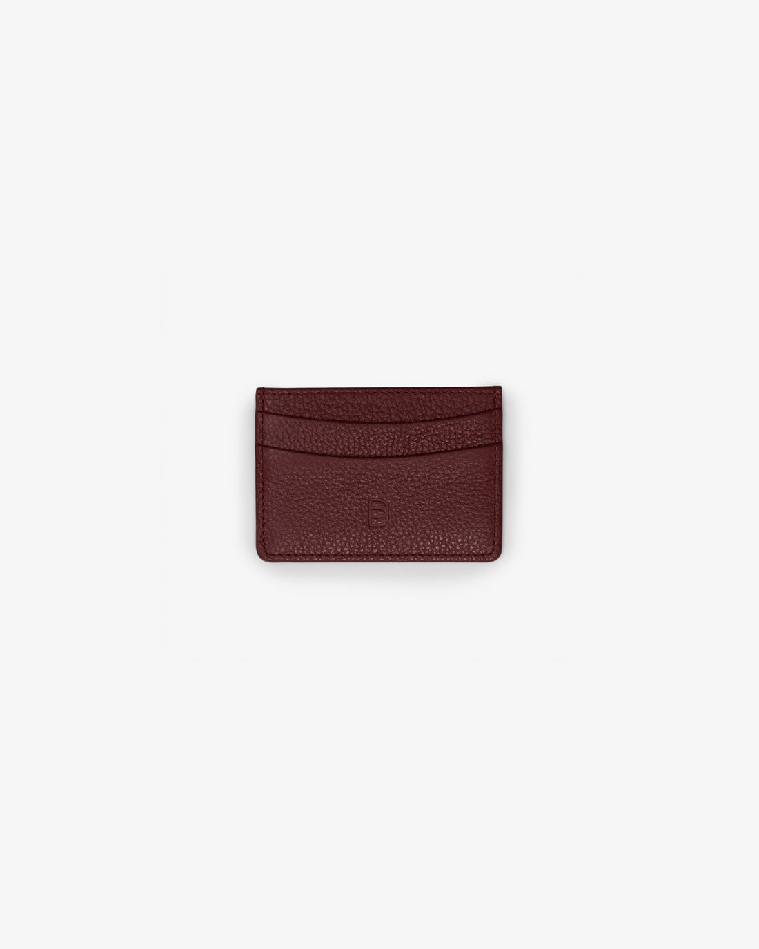 A small dark red textured leather card holder wallet centered on a light gray background.