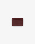 A small dark red textured leather card holder wallet centered on a light gray background.