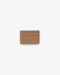 A slim, minimalist card holder or wallet made of textured tan leather, shown flat against a solid white background.