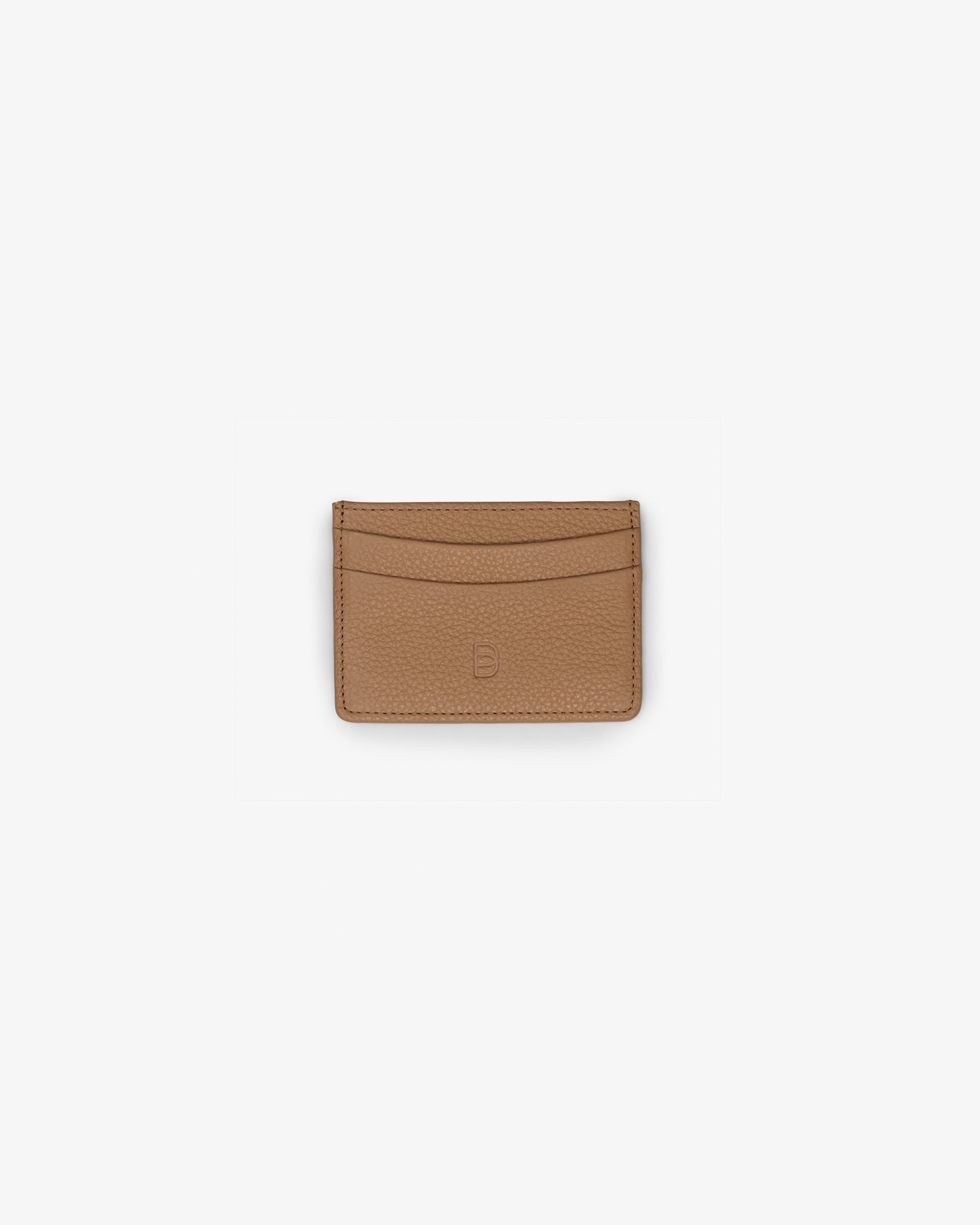 A slim tan leather card holder wallet with curved card slots and a debossed "B" logo on the front, centered on a plain white background.