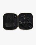 An open black zippered carrying case with gold-tone zipper trim, shown against a light gray background. Inside, black cables and accessories are organized in mesh pockets and elastic loops.