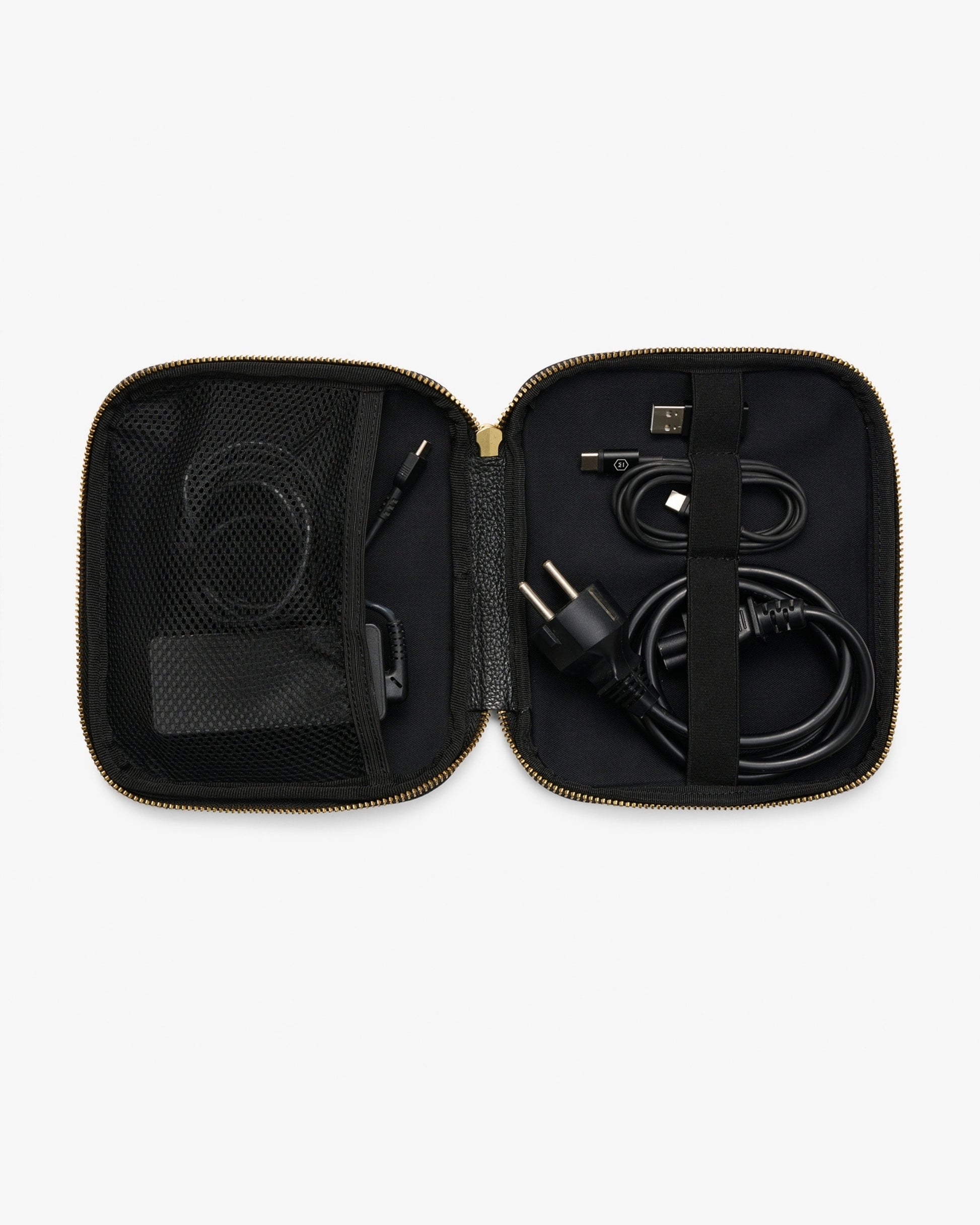 An open black zippered carrying case with gold-tone zipper trim, shown against a light gray background. Inside, black cables and accessories are organized in mesh pockets and elastic loops.