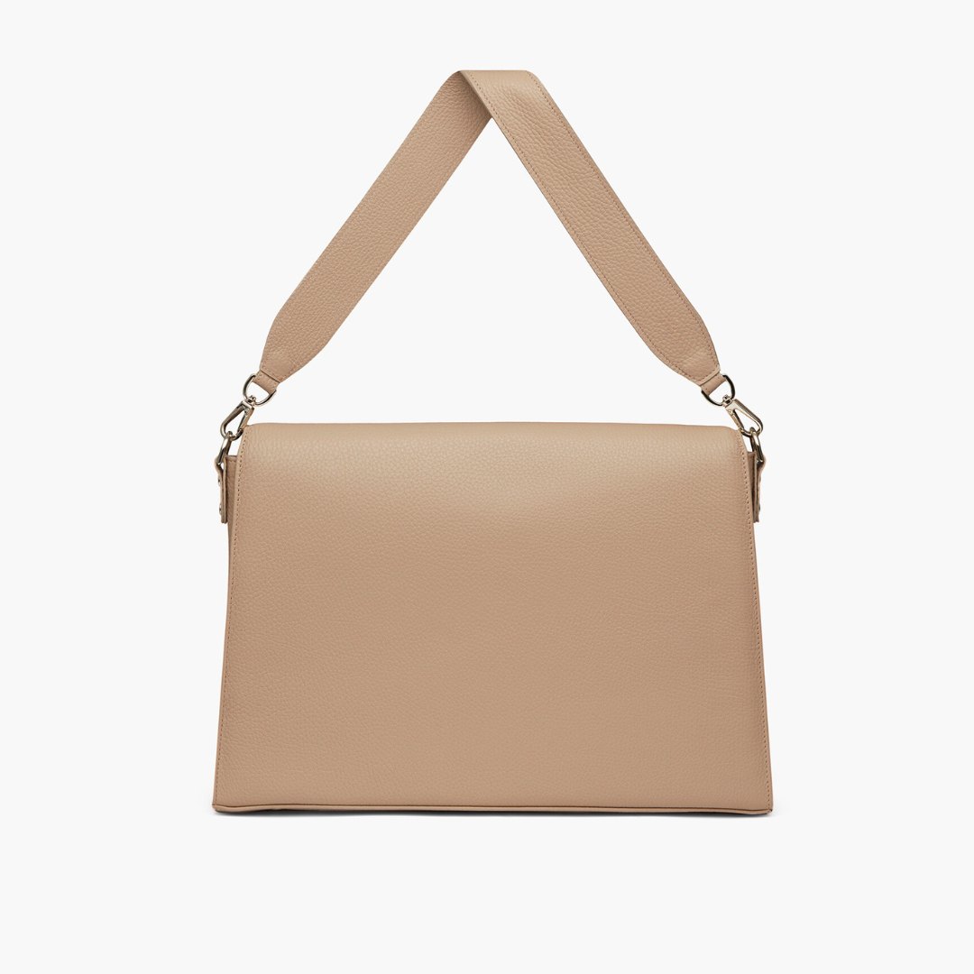 A beige laptop bag with grained leather and light gold metalware. It has a detachable shoulder strap. 