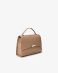 A structured top-handle handbag in a warm tan or camel beige leather, shown from a three-quarter angle against a clean, light off-white background.
